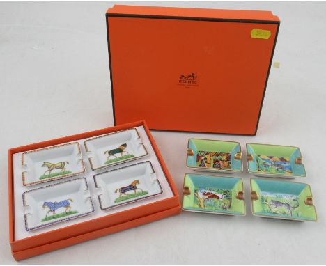 A boxed set of four Hermes porcelain ashtrays, printed with racehorses, together with another boxed set printed with wild ani