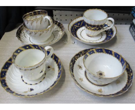 Two Worcester first period tea cups and saucers, together with a tea bowl and saucer and a trio