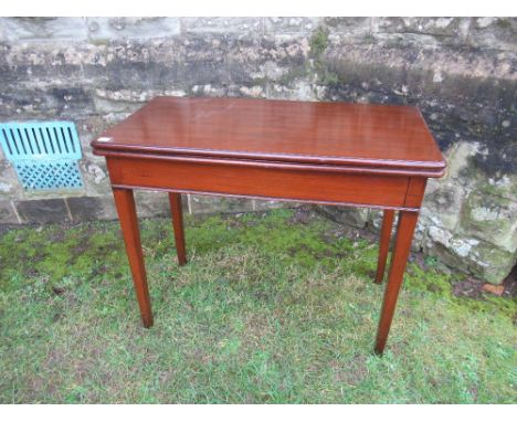 A 19th century mahogany fold over card table