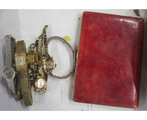 A collection of wrist watches, and a cigarette case
