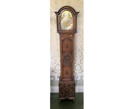 Carved Oak Grandmother Brass Faced Clock with Pendulum and Key 69" High. 1 small Piece of carving at the bottom missing