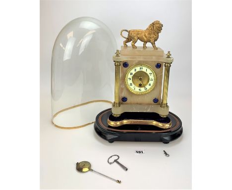 Onyx and brass clock with lion adornment on stand in glass dome. No back plate. With pendulum and key. Clock  9” w x 15”h, to