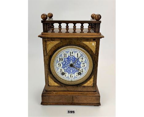 Walnut gallery top 2-hole mantle clock with blue/white enamel face and brass inlay. With pendulum and key. Label inside ‘Henr