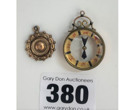 9k gold pendant and 9k gold rimmed compass 1.25” long, total w: 7.1 gms