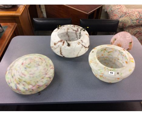 A collection of four glass light shades