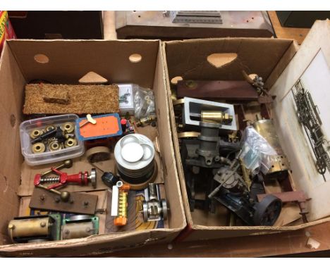 Two boxes of model engine parts