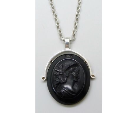 A white metal mounted carved jet plaque depicting a portrait of a lady, on a silver belcher chain, 5cm pendant including bale