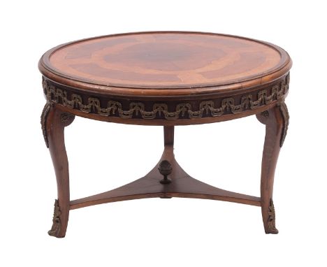 A walnut, kingwood and gilt metal mounted low table in Louis XVI taste, 20th century; the circular top with quarter veneers w