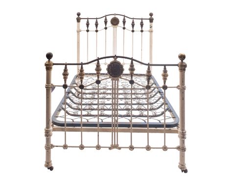 A Victorian painted iron and brass mounted double bed, in Aesthetic style, late 19th century; the openwork head and footboard