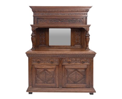 A carved oak side cabinet in Flemish 17th century style, late 19th century; the superstructure with moulded and lunette carve
