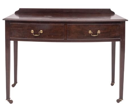 A Victorian mahogany wash table in George III style, circa 1880; bow fronted, with back gallery and twin drawers, both with a