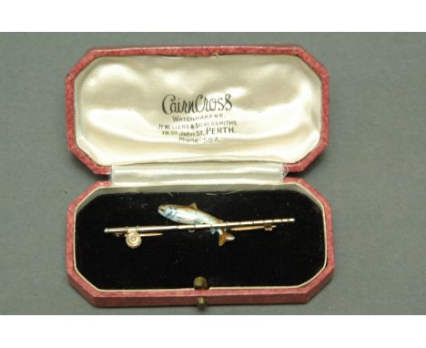 9 ct gold brooch in the form of fishing rod and reel, the reel with inset pearl decoration, and enamel salmon, reel stamped A