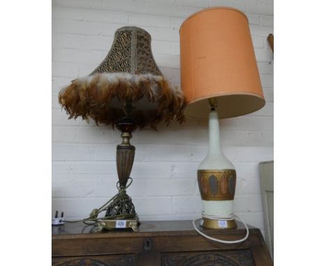 A decorative urn shaped table lamp with feather decorated shade and a china lamp with orange shade 