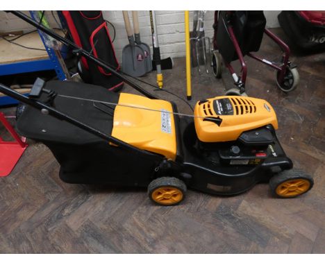 A yellow McCulloch petrol engine lawn mower 