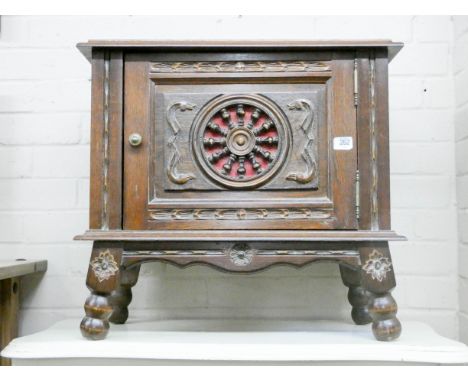 A Breton oak bedside cabinet with spoke wheel shaped door