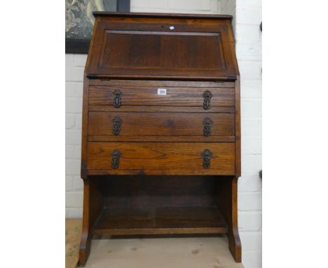 A student style oak bureau with three drawers under with the bottom shelf, 2' wide 