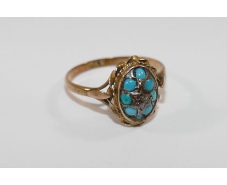 A Victorian 15 carat gold turquoise and diamond oval cluster ring, the central rose cut diamond within eight turquoise caboch
