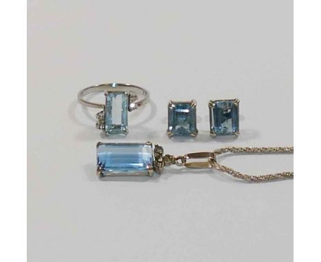 A matched aquamarine and diamond suite of jewellery comprised of a ring, finger size M, earrings and pendant, all set in whit