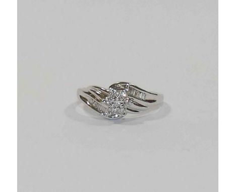 A diamond set daisy cluster cross over ring, combined weight approximately 0.25 carats, all set in white stamped '14K', finge