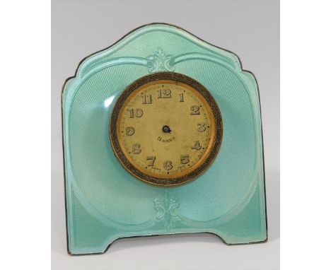 A silver coloured metal and guilloche enamelled easel backed clock, the face with Arabic numerals and gilt brass Greek key su