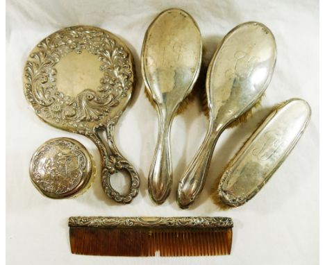 A silver topped cut glass jar, Birmingham 1900, the lid embossed with a musician and two ladies, 7cm diameter, a silver backe