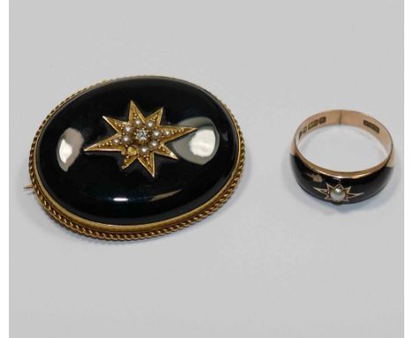 A Victorian 15 carat gold and black onyx set oval mourning brooch, the centre set with gold, half seed pearl and diamond set 