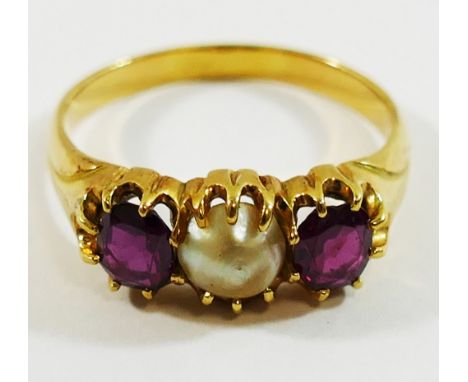 A yellow metal garnet and mabè pearl three stone ring, the stones within claw setting, the shank unmarked, finger size P, 4.3