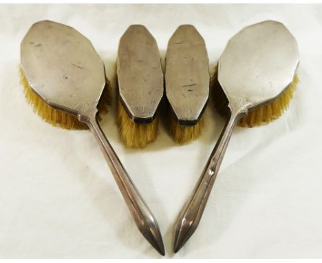 A pair of silver backed long handled hair brushes, with engine turned decoration, Birmingham 1935, and a pair of matching sma