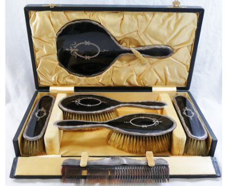 A silver and tortoiseshell backed six piece brush and mirror set comprised of a hand mirror, four brushes and a comb, Birming