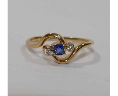 An early 20th century 18 carat gold sapphire and diamond cross over ring, the old cut diamonds each approximately 0.05 carats
