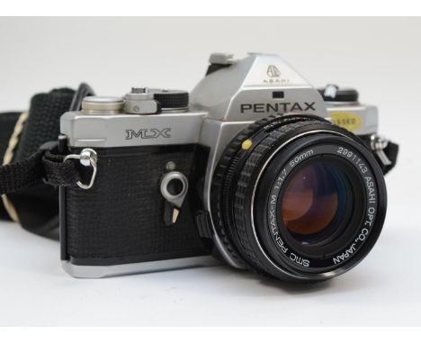 A Pentax MX 35mm film camera, with a Asahi Pentax 50mm f1.7, with manual, working, lens may require a clean 