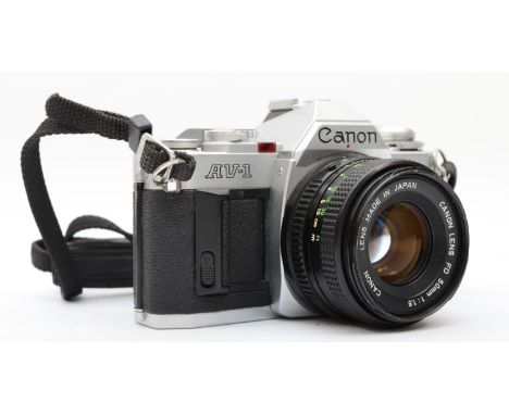 A Canon AV-1 35mm film camera, with a Canon 50mm f1.8 lens, with manuals, working, lens may require a clean 