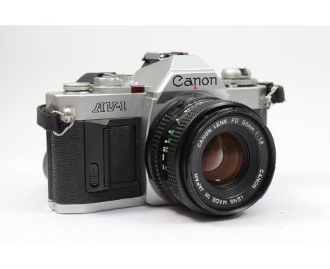 A Canon AV-1 35mm film camera, with a Canon FD 50mm f1.8 lens, working, lens may require a clean 