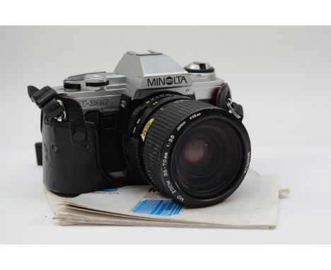 A Minolta X-300 35mm film camera, with a Minolta 35mm-70mm f3.5, with manual and Minolta MD lenses owners manual, working, le