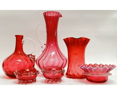 A group of Victorian cranberry glass comprising a large pitcher (h- 28cm, w- 14cm), a smaller pitcher (possibly missing stopp