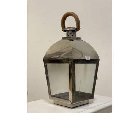 A stainless steel candle lantern of tapered form inset with glass panels. H52cm. 