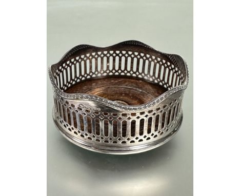 A Mappin &amp; Webb modern silver wine coaster with pierced sides and gadroon border inset mahogany base baize lined verso H 