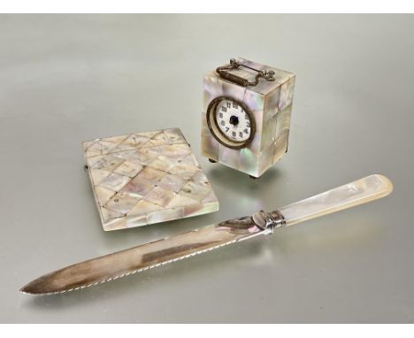 A group of mother-of-pearl items, late 19th/early 20th century comprising: a miniature table clock (a/f), bread knife with si