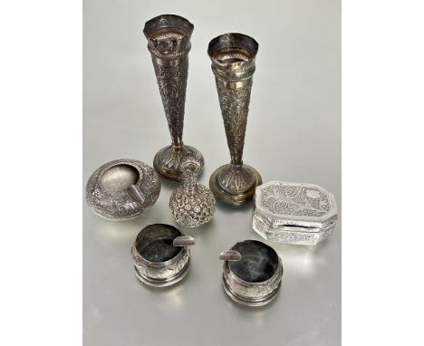 A collection of Eastern white metal wears to include a pair or trumpet shaped table posy vases on circular bases H x 18cm, a 