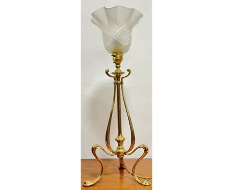 In the manner of W.A.S. Benson, an Art Nouveau lacquered brass tripod lamp of linear form with frosted shade (h- 47cm)