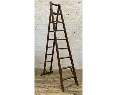 A set of early 20th century pitch pine extending ladders, 'The patent safety ladder' H258cm (minimum)&nbsp;
