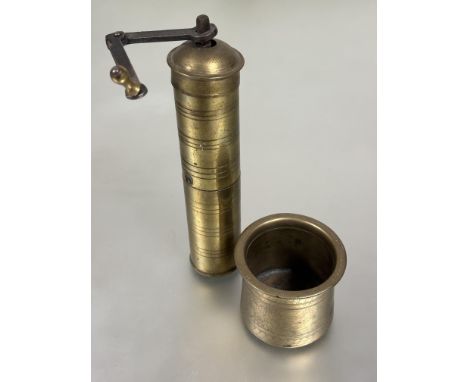 An vintage Indian brass circular column pepper mill with steel handle H x 21cm D x 4.5cm and a brass spices mortar with engra