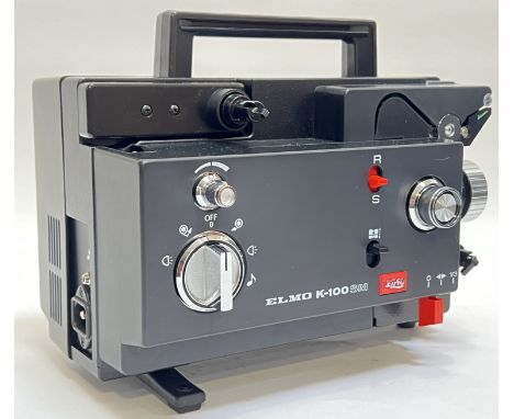 An Elmo K-100SM cine film projector with original case, appliances, and manual