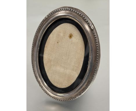 Edwardian Birmingham silver oval photograph frame with chased dart border with original ebony back and easel stand inner H x 