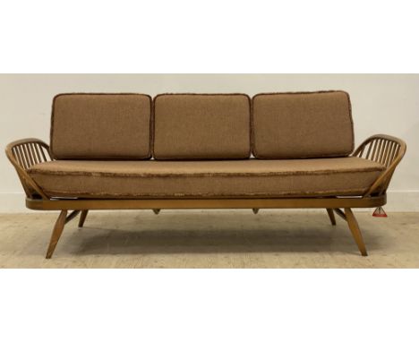 Ecol, a light elm and beech 'Surfboard' sofa, panel back above hoop and spindle arms, the squab cushions upholstered in light