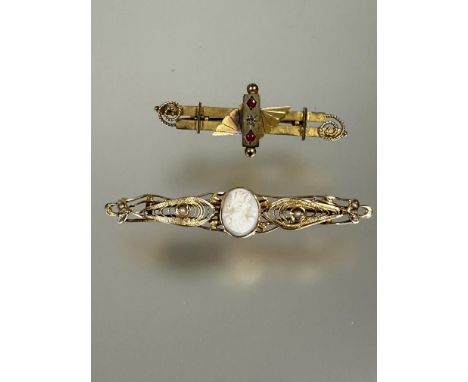 A 10k gold brooch set central oval shell carved portrait cameo flanked by seed pearl set filigree panels L x 5,.5cm 3.1g and 