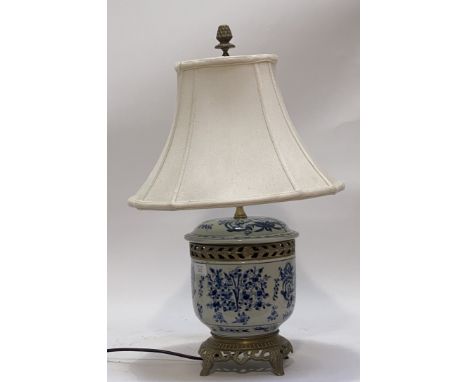 A vintage blue and white ceramic table lamp with floral cast openwork brass mounts. H60cm.&nbsp;