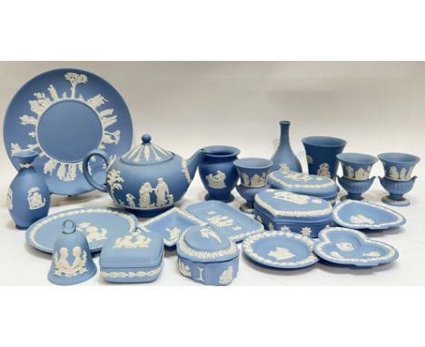 A large group of Wedgwood Jasperware items, all with sprigged decoration on light blue ground, comprising a teapot, a tea pla
