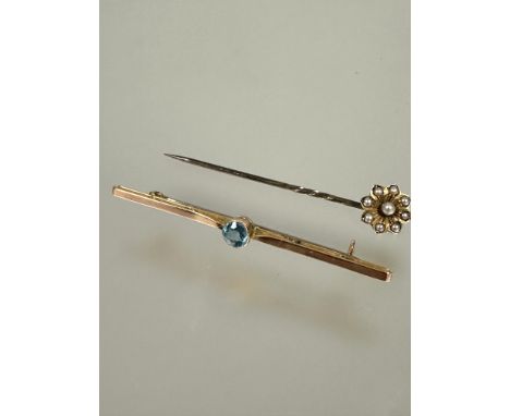 An Edwardian 9ct rose gold bar brooch set circular faceted blue zircon small chip to edge and repair to shoulder L x 6.5cm 2.