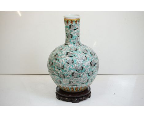 Large Chinese blue ground bottle vase, the enamel decoration depicting cranes in-flight amongst trailing flowers, repeating f